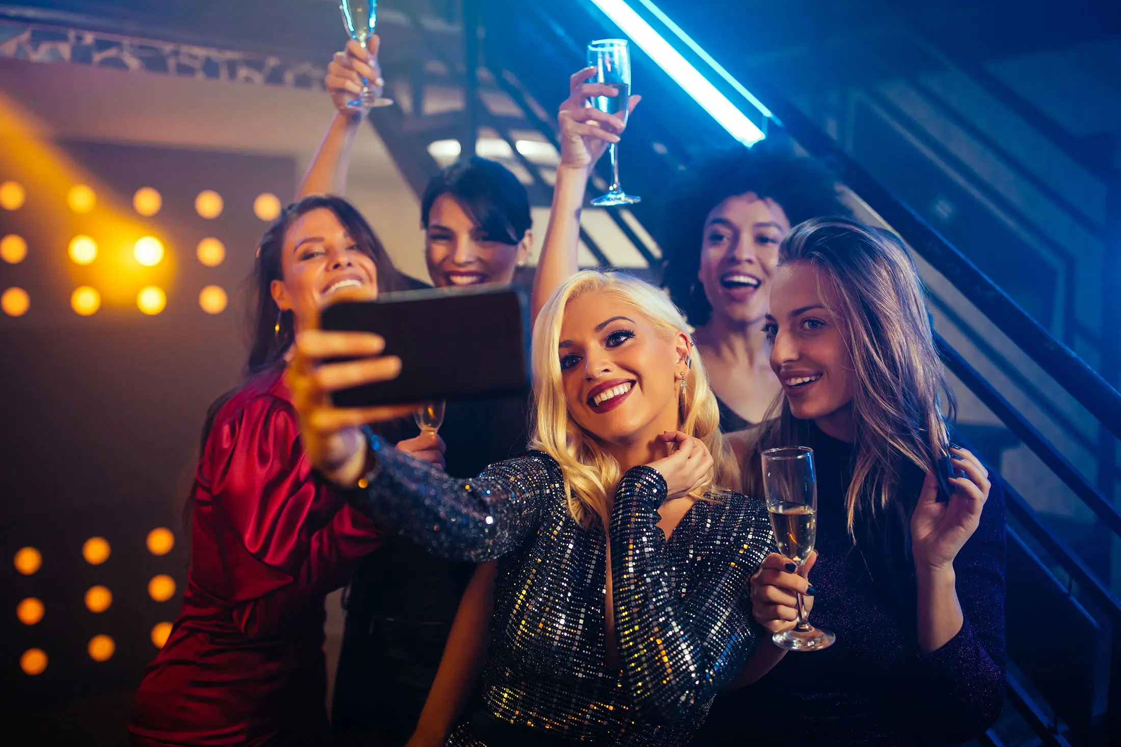women taking selfie and drinking champagne