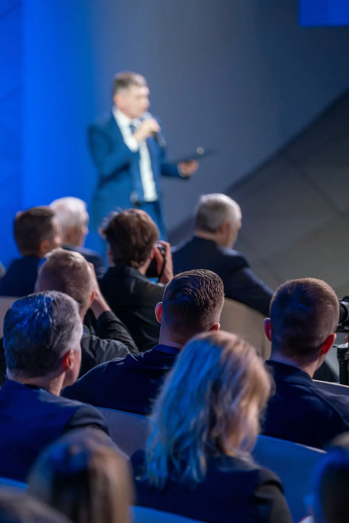 man in suit speaking at event